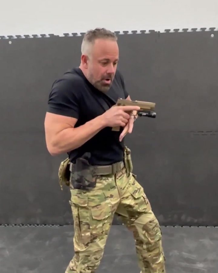 Adam drawing a pistol from the holster