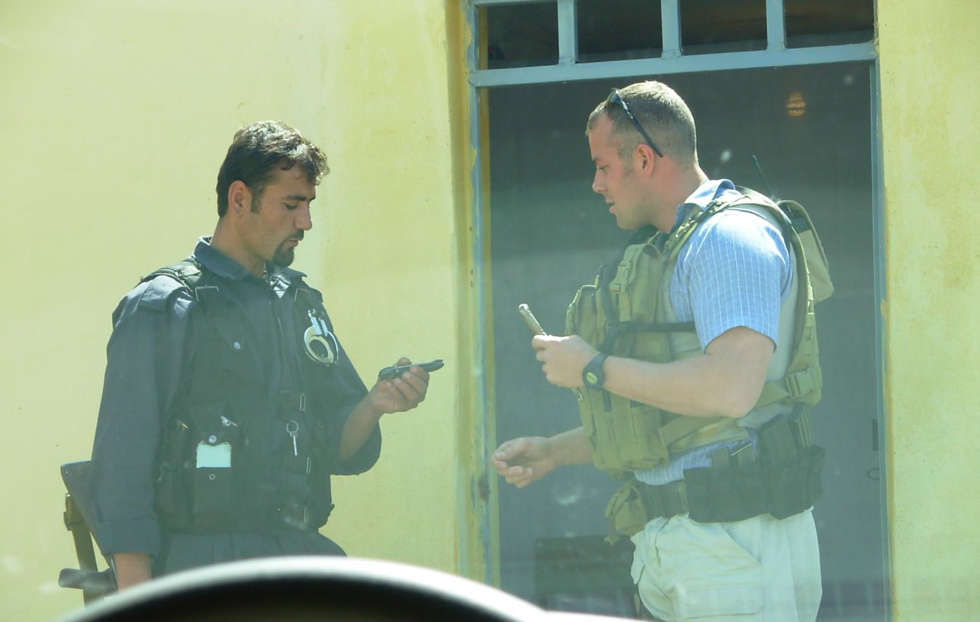 Adam Seegmiller in body armor at a checkpoint overseas